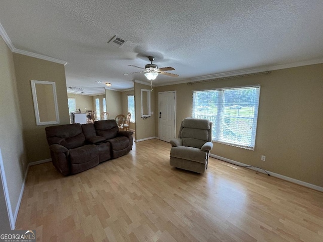 1640 Hg Miles Dr NE, Townsend, GA 31331 - living room featuring baseboards, crown molding, light wood finished floors, and visible vents