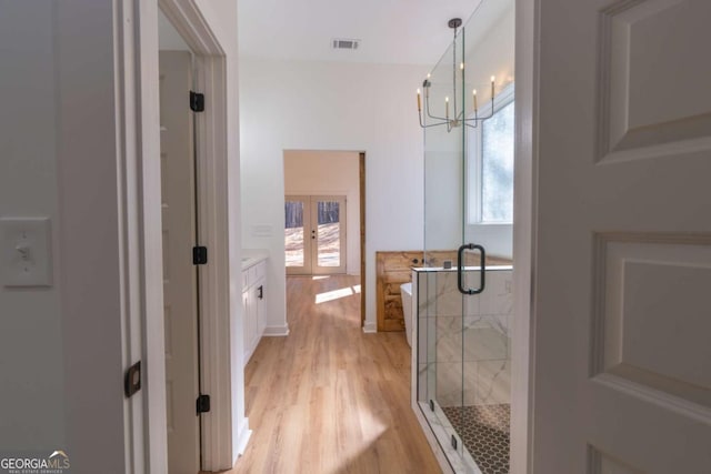 1250 Hayes Mill Rd, Carrollton, GA 30117 - full bathroom with french doors, a shower stall, a soaking tub, and vanity