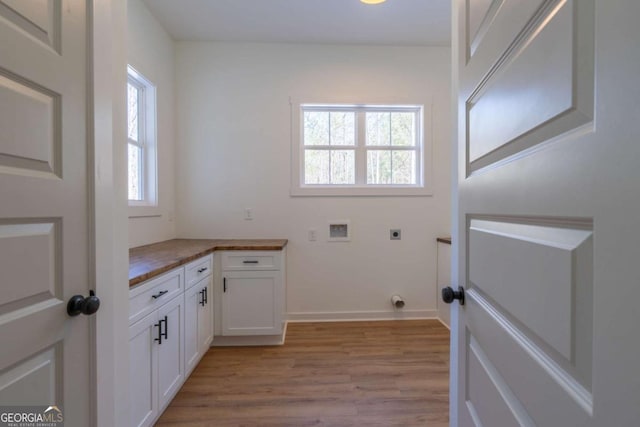 1250 Hayes Mill Rd, Carrollton, GA 30117 - laundry room with hookup for an electric dryer, light wood finished floors, washer hookup, and cabinet space