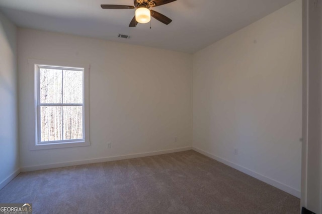1250 Hayes Mill Rd, Carrollton, GA 30117 - carpeted empty room with healthy amount of natural light and ceiling fan