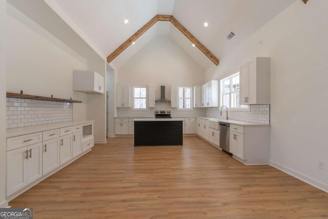 1250 Hayes Mill Rd, Carrollton, GA 30117 - kitchen with wall chimney exhaust hood, high vaulted ceiling, appliances with stainless steel finishes, backsplash, and white cabinetry