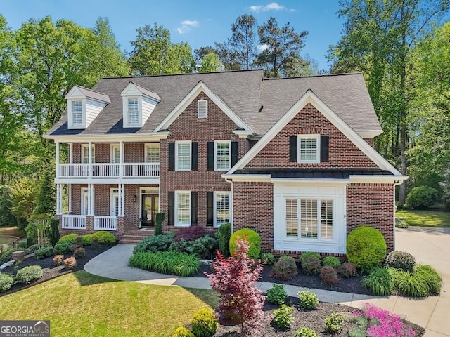 3115 Corsair Curv, Cumming, GA 30040 - view of front facade featuring brick siding, a porch, a balcony, a front yard, and a shingled roof