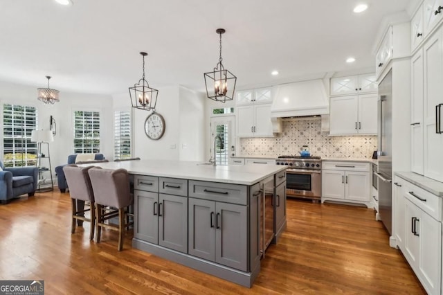 3115 Corsair Curv, Cumming, GA 30040 - kitchen with stainless steel range, gray cabinetry, white cabinetry, premium range hood, and recessed lighting