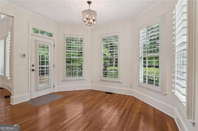 3115 Corsair Curv, Cumming, GA 30040 - unfurnished dining area with wood finished floors, ornamental molding, a chandelier, plenty of natural light, and baseboards
