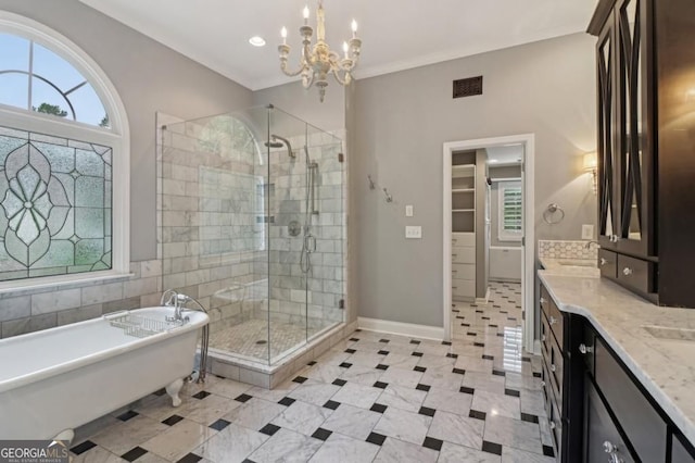 3115 Corsair Curv, Cumming, GA 30040 - bathroom featuring a stall shower, a soaking tub, vanity, a walk in closet, and ornamental molding