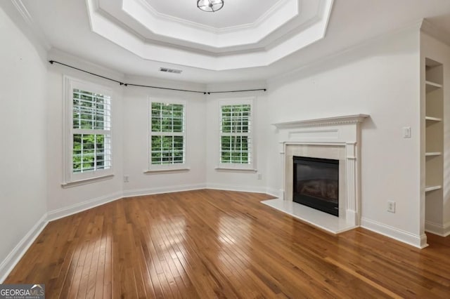 3115 Corsair Curv, Cumming, GA 30040 - unfurnished living room featuring hardwood / wood-style floors, ornamental molding, a tray ceiling, a fireplace, and baseboards