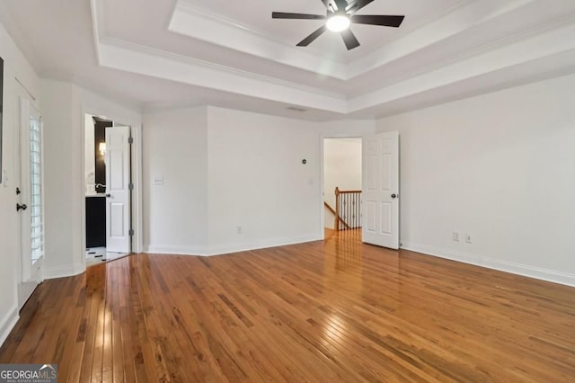3115 Corsair Curv, Cumming, GA 30040 - empty room with a tray ceiling, hardwood / wood-style floors, ceiling fan, ornamental molding, and baseboards