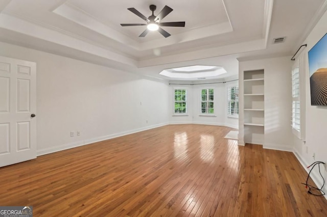 3115 Corsair Curv, Cumming, GA 30040 - unfurnished living room featuring a tray ceiling, wood-type flooring, ceiling fan, and baseboards
