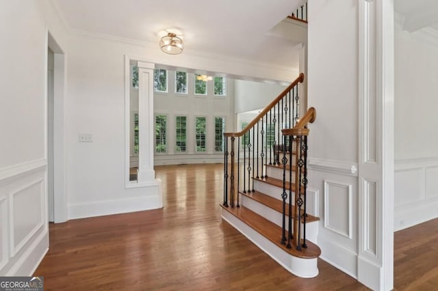 3115 Corsair Curv, Cumming, GA 30040 - foyer featuring a decorative wall, stairs, wood finished floors, ornamental molding, and wainscoting