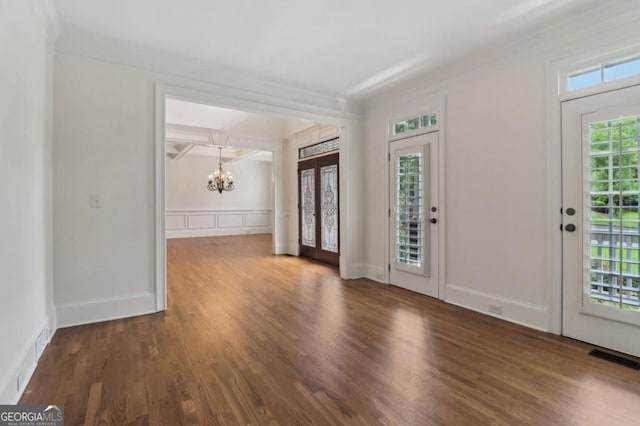 3115 Corsair Curv, Cumming, GA 30040 - foyer entrance featuring a chandelier, wood finished floors, ornamental molding, a decorative wall, and a wainscoted wall