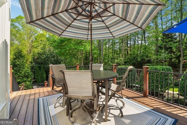 3115 Corsair Curv, Cumming, GA 30040 - wooden terrace with outdoor dining space and view of wooded area