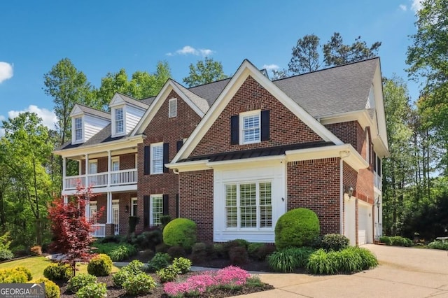 3115 Corsair Curv, Cumming, GA 30040 - colonial home featuring brick siding, concrete driveway, a balcony, and a garage