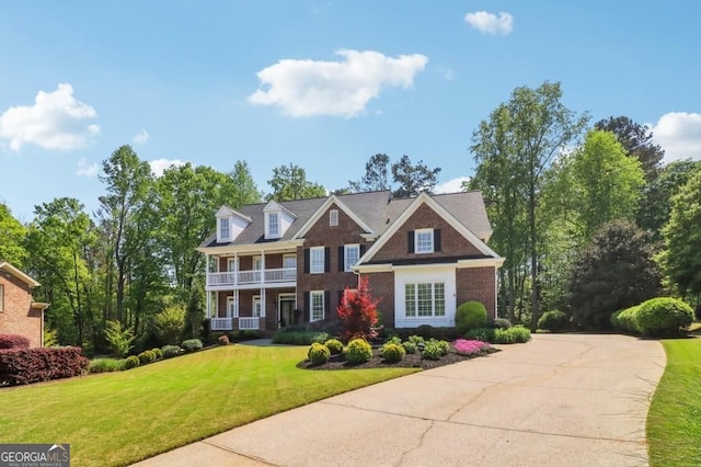 3115 Corsair Curv, Cumming, GA 30040 - colonial inspired home with a balcony, a front yard, and brick siding