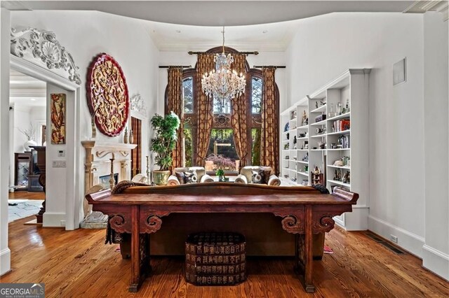 2120 Blackheath Trce, Alpharetta, GA 30005 - dining space featuring a chandelier, a decorative wall, crown molding, a wainscoted wall, and wood finished floors