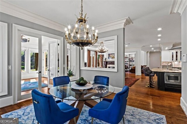 2120 Blackheath Trce, Alpharetta, GA 30005 - living room featuring wood finished floors, a chandelier, crown molding, and a fireplace
