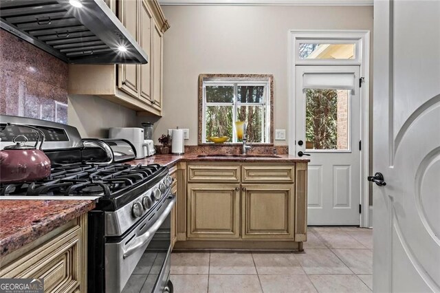 2120 Blackheath Trce, Alpharetta, GA 30005 - kitchen with stainless steel range with gas cooktop, range hood, cream cabinets, and light tile patterned flooring