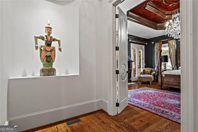 2120 Blackheath Trce, Alpharetta, GA 30005 - corridor featuring crown molding, wood finished floors, and a chandelier