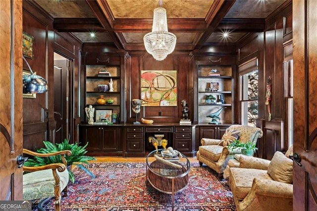 2120 Blackheath Trce, Alpharetta, GA 30005 - living area with built in shelves, wooden walls, a chandelier, coffered ceiling, and ornamental molding