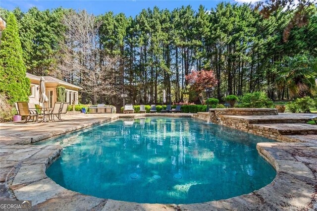 2120 Blackheath Trce, Alpharetta, GA 30005 - outdoor pool with a patio area and view of scattered trees