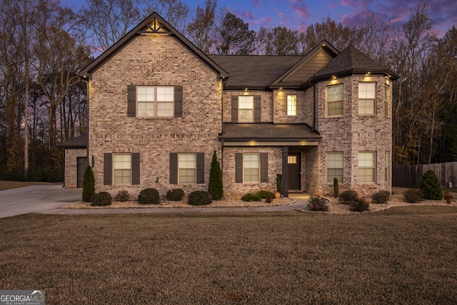 810 Relic Rdg, Hampton, GA 30228 - traditional-style home featuring a front lawn, concrete driveway, fence, brick siding, and a shingled roof