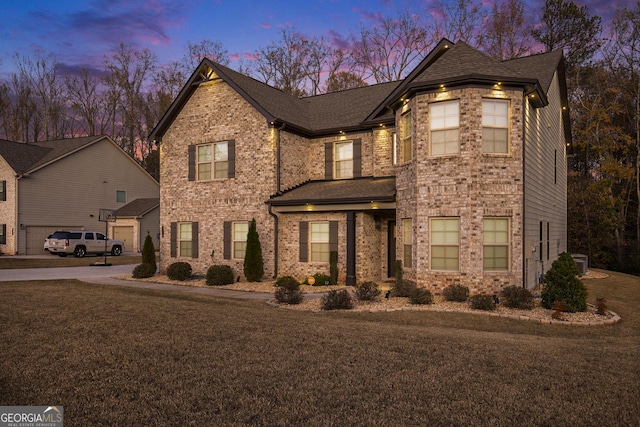 810 Relic Rdg, Hampton, GA 30228 - traditional home with central AC, brick siding, a yard, and a shingled roof