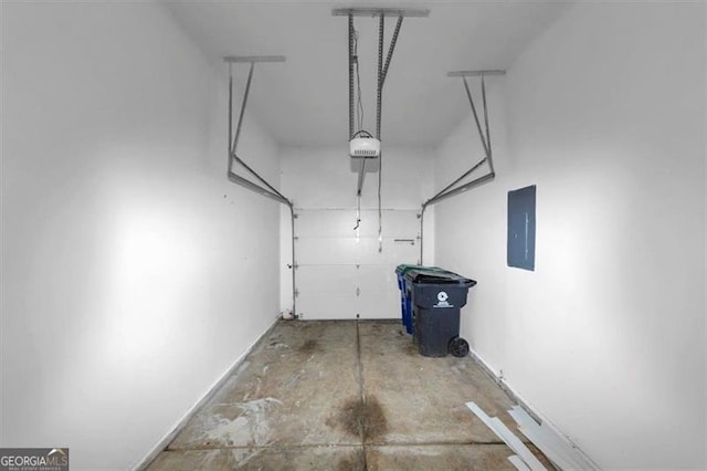 garage featuring electric panel and a garage door opener