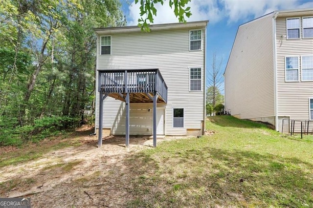 back of property with a lawn and a wooden deck