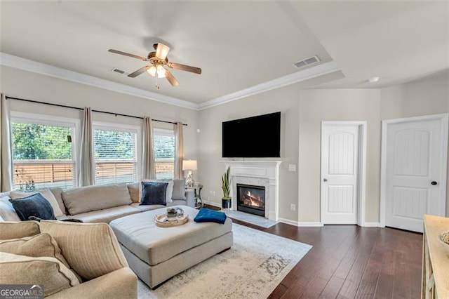 living room featuring a wealth of natural light, a ceiling fan, baseboards, and visible vents