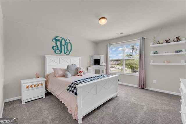 bedroom with baseboards, visible vents, and carpet