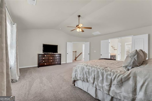 bedroom featuring light colored carpet, lofted ceiling, multiple windows, and baseboards
