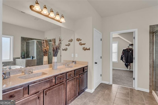 full bathroom featuring tile patterned flooring, a sink, double vanity, and a stall shower