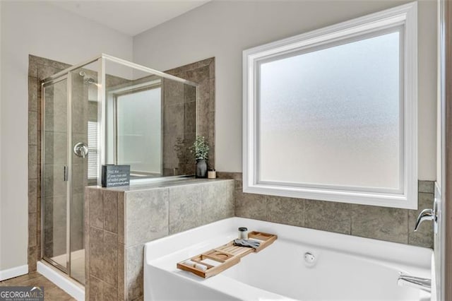 bathroom featuring a shower stall and a bathing tub