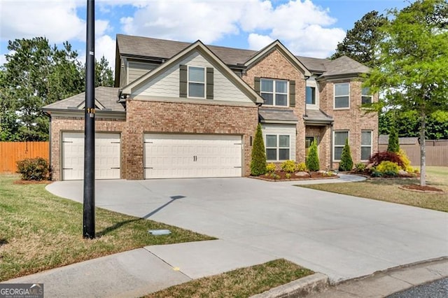 craftsman house featuring brick siding, driveway, a front lawn, and fence