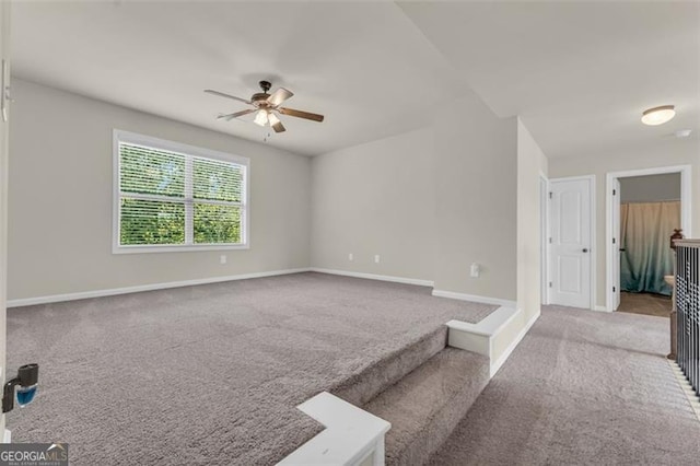empty room with baseboards, carpet, and ceiling fan