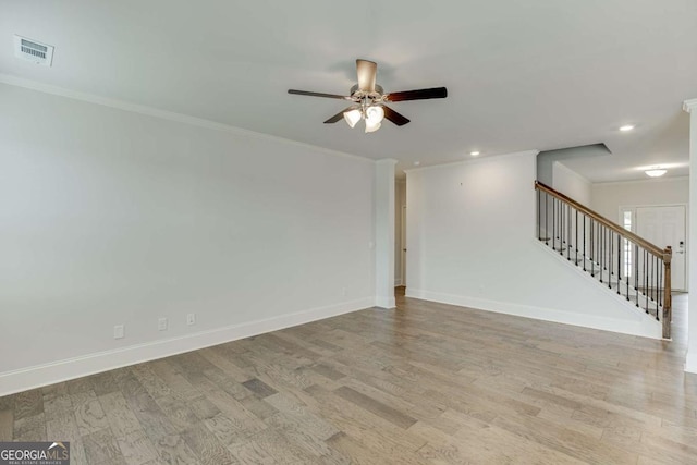 7208 Whitewater Dr, Flowery Branch, GA 30542 - empty room featuring ceiling fan, stairs, light wood-style floors, ornamental molding, and recessed lighting