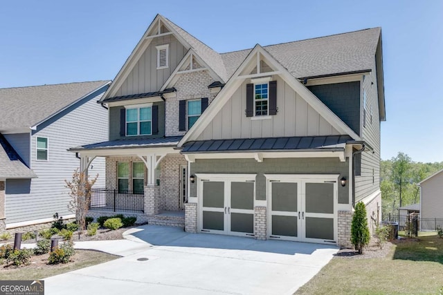 7208 Whitewater Dr, Flowery Branch, GA 30542 - craftsman house featuring covered porch, board and batten siding, a standing seam roof, concrete driveway, and brick siding
