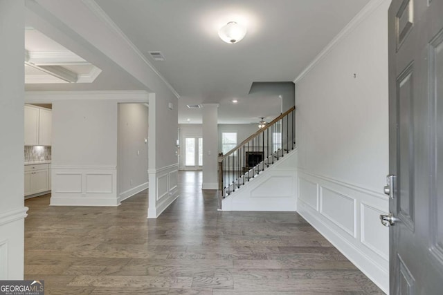 7208 Whitewater Dr, Flowery Branch, GA 30542 - entrance foyer featuring a decorative wall, wood finished floors, stairs, crown molding, and a ceiling fan