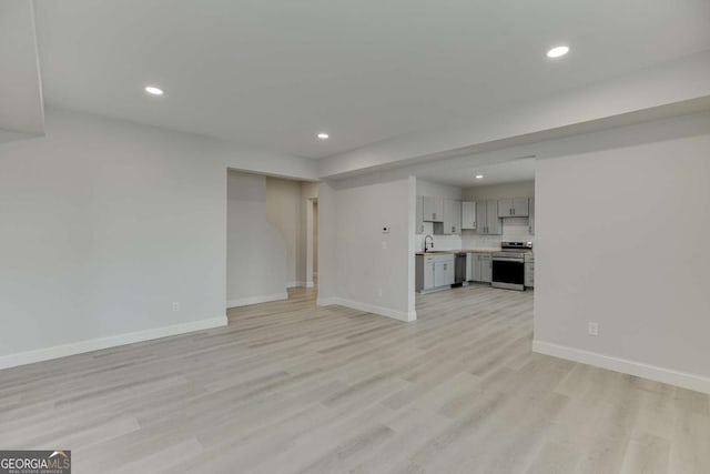 7208 Whitewater Dr, Flowery Branch, GA 30542 - unfurnished living room featuring recessed lighting and light wood-type flooring