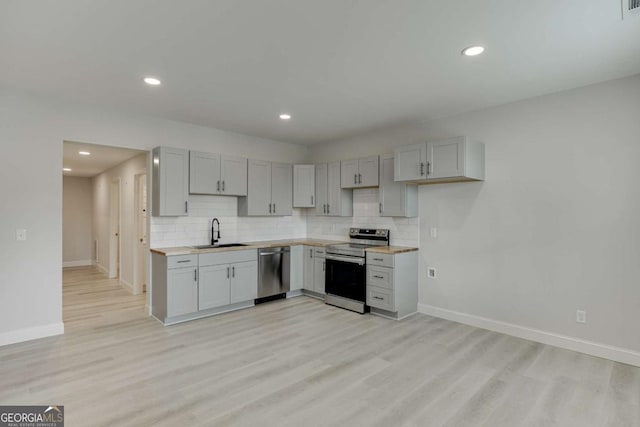 7208 Whitewater Dr, Flowery Branch, GA 30542 - kitchen with appliances with stainless steel finishes, tasteful backsplash, light countertops, and recessed lighting