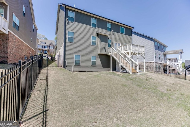 7208 Whitewater Dr, Flowery Branch, GA 30542 - rear view of property with stairway, a fenced backyard, and a residential view