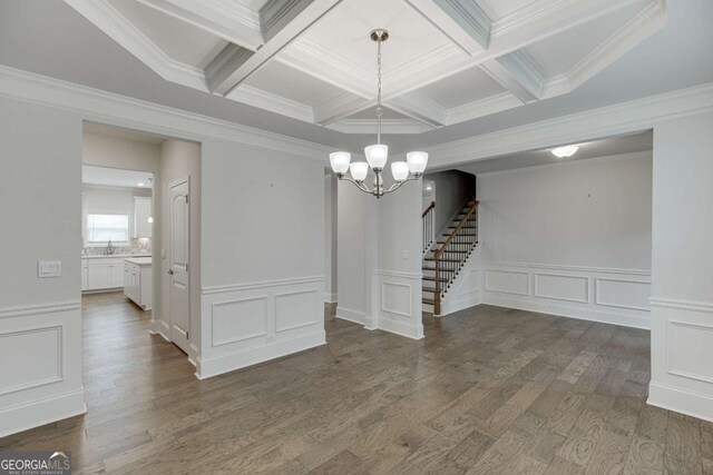 7208 Whitewater Dr, Flowery Branch, GA 30542 - unfurnished dining area with a decorative wall, coffered ceiling, a chandelier, crown molding, and stairs