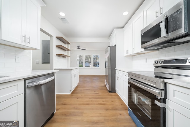 2215 Gordon Cir SE, Smyrna, GA 30080 - kitchen featuring white cabinets, stainless steel appliances, visible vents, backsplash, and open shelves
