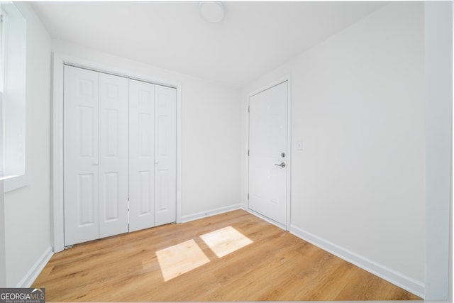 2215 Gordon Cir SE, Smyrna, GA 30080 - unfurnished bedroom with baseboards, light wood finished floors, and a closet