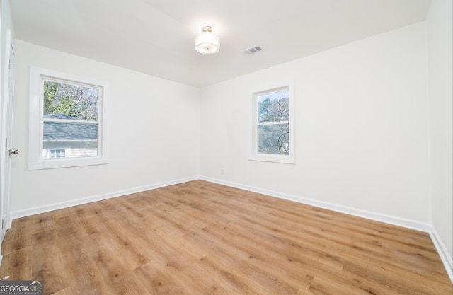 2215 Gordon Cir SE, Smyrna, GA 30080 - unfurnished room with baseboards, visible vents, and light wood-style flooring
