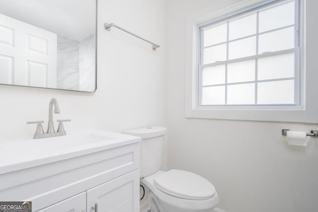 2215 Gordon Cir SE, Smyrna, GA 30080 - bathroom featuring toilet, vanity, and baseboards