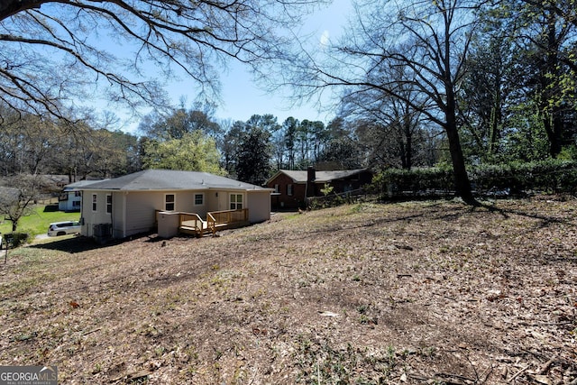 2215 Gordon Cir SE, Smyrna, GA 30080 - view of yard with central air condition unit and a deck