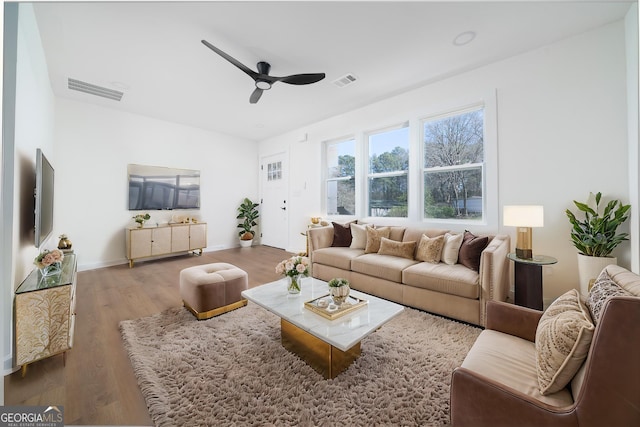 2215 Gordon Cir SE, Smyrna, GA 30080 - living room featuring wood finished floors, visible vents, baseboards, and ceiling fan
