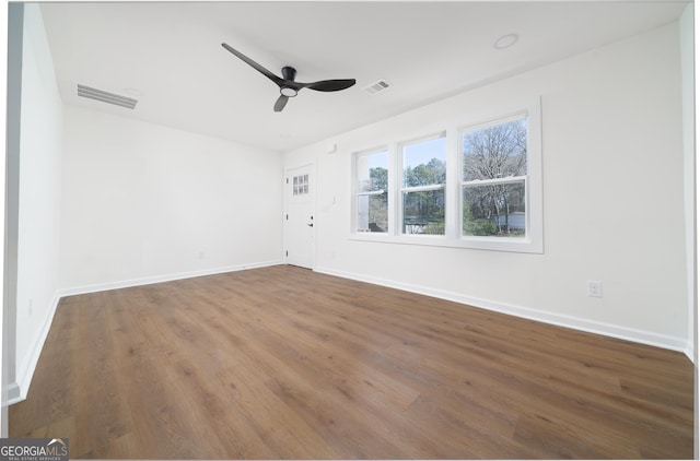 2215 Gordon Cir SE, Smyrna, GA 30080 - empty room featuring wood finished floors, visible vents, a ceiling fan, and baseboards