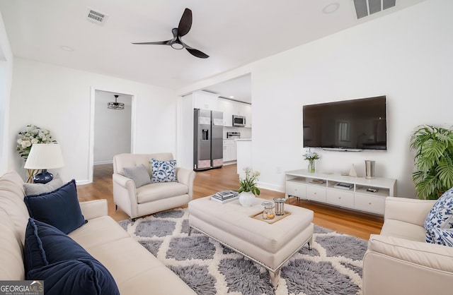 2215 Gordon Cir SE, Smyrna, GA 30080 - living room featuring light wood-style flooring, visible vents, and ceiling fan