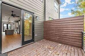 wooden deck with a ceiling fan